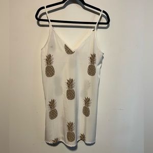 White dress with gold pineapples.